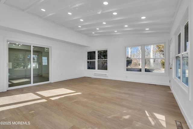 unfurnished sunroom featuring lofted ceiling with beams and visible vents