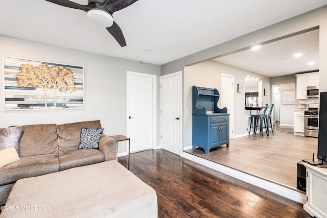 living room featuring hardwood / wood-style flooring and ceiling fan