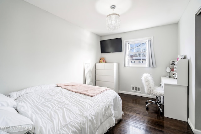 bedroom with dark hardwood / wood-style flooring