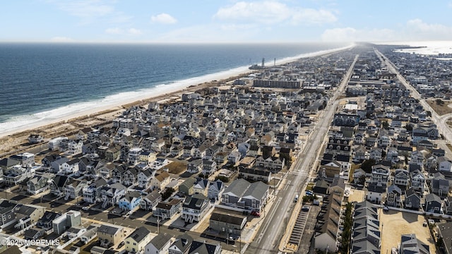 birds eye view of property featuring a beach view and a water view