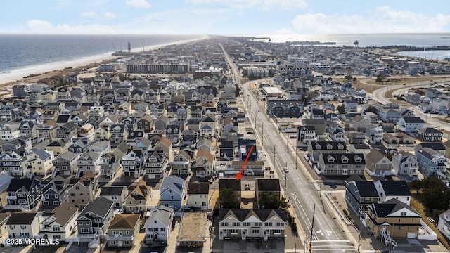 bird's eye view featuring a water view and a beach view