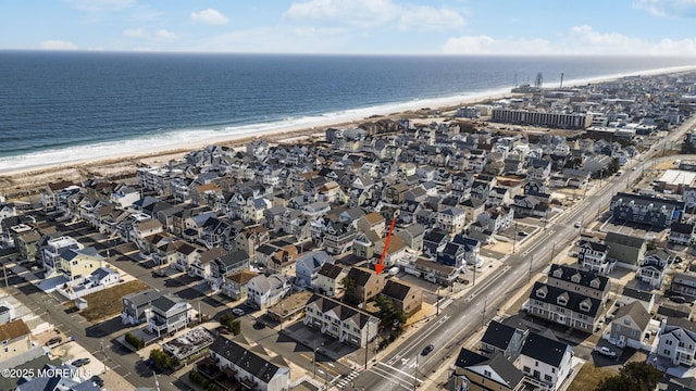 bird's eye view with a water view and a beach view