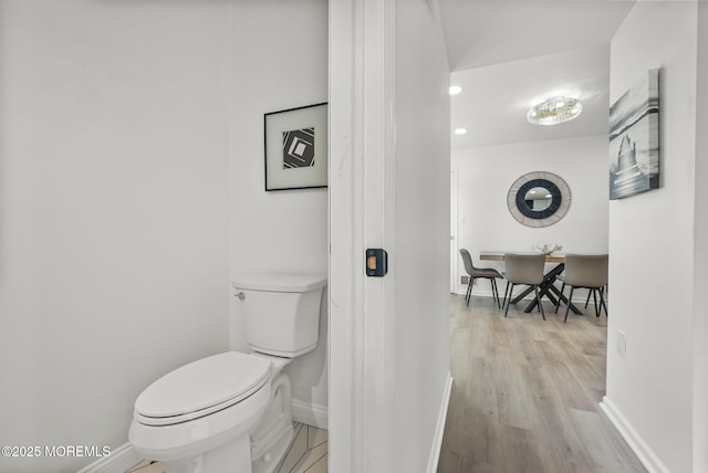 bathroom with wood-type flooring and toilet