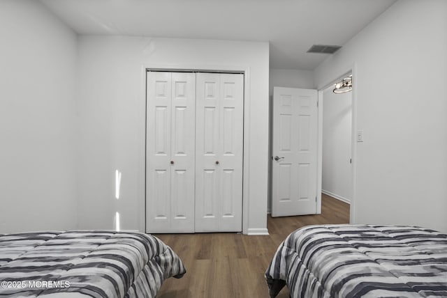 bedroom featuring a closet and dark hardwood / wood-style floors