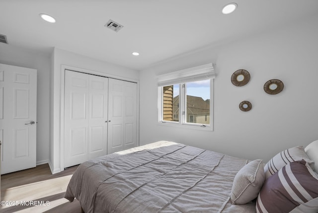 bedroom featuring hardwood / wood-style floors and a closet