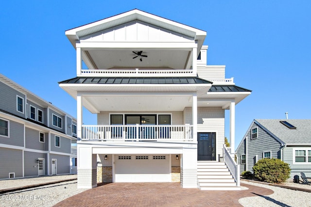 view of front of house featuring a garage and ceiling fan