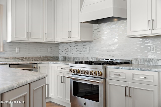 kitchen featuring white cabinetry, high end stainless steel range, and custom range hood