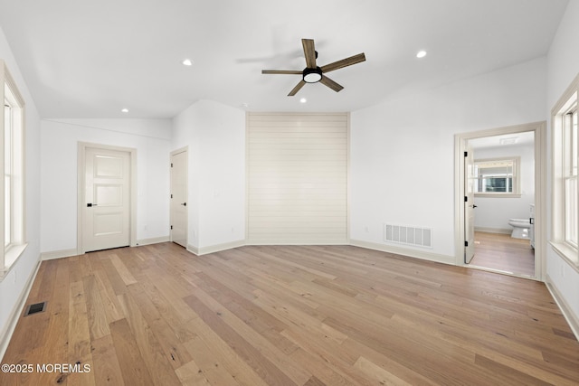 unfurnished living room featuring ceiling fan and light hardwood / wood-style flooring