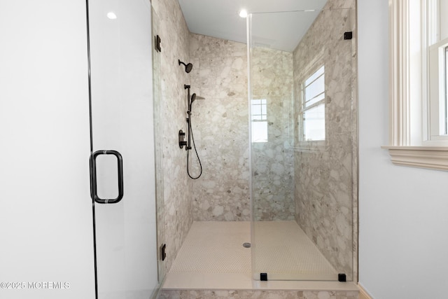 bathroom featuring a shower with door