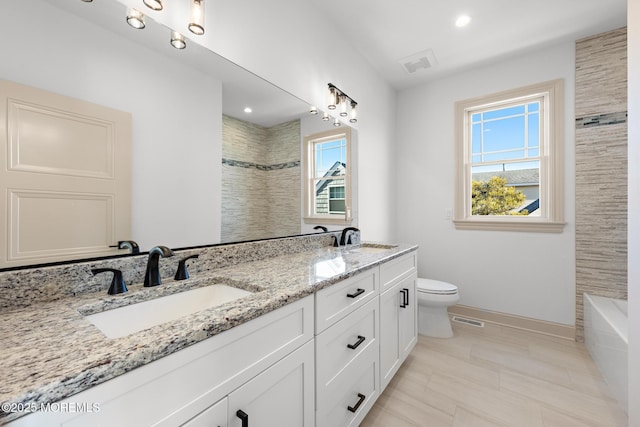 bathroom featuring vanity and toilet