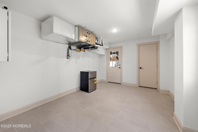 basement with stainless steel refrigerator