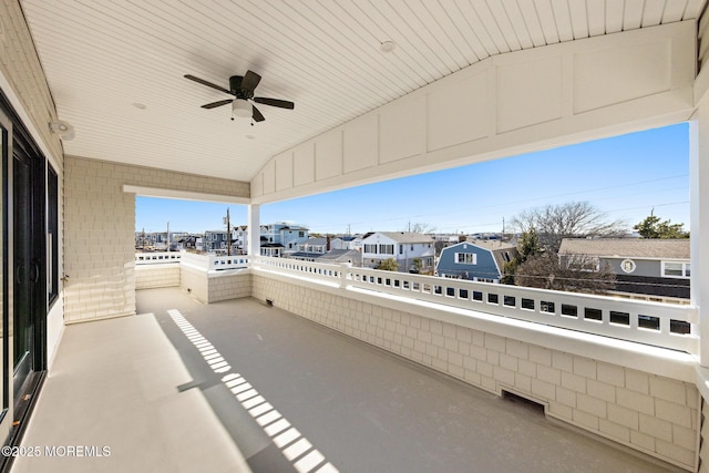 view of patio with a balcony and ceiling fan