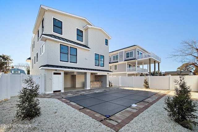 rear view of property featuring a patio area