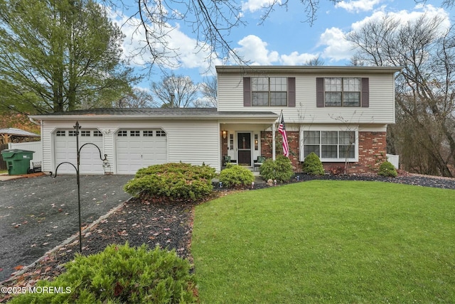 view of front property featuring a garage and a front yard