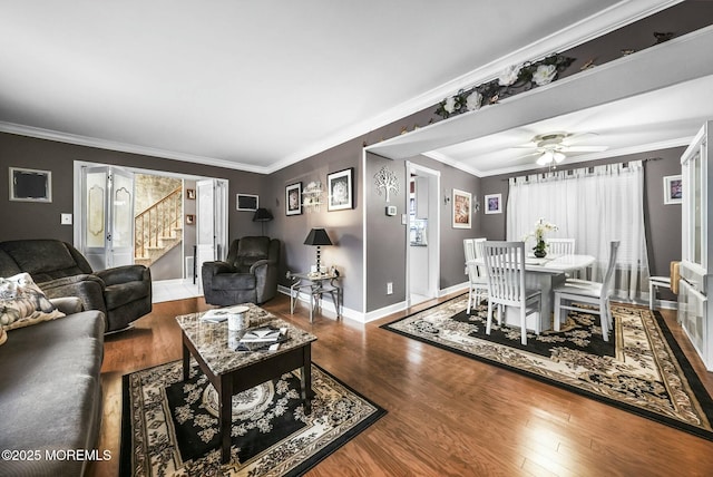 living room featuring ceiling fan, ornamental molding, and hardwood / wood-style floors