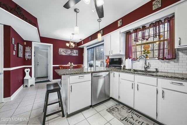 kitchen featuring sink, decorative light fixtures, stainless steel dishwasher, kitchen peninsula, and white cabinets