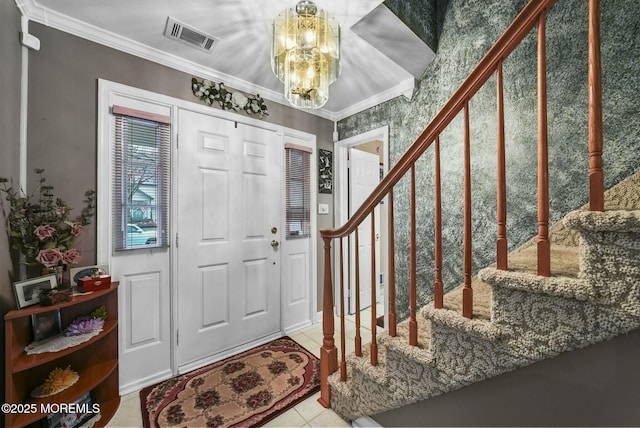 foyer entrance with an inviting chandelier, light tile patterned floors, and crown molding