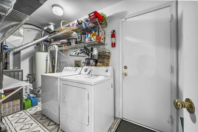 washroom with water heater and washer and dryer