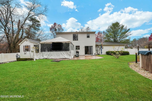 back of property with a gazebo, a patio area, and a lawn