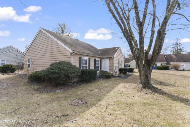 view of home's exterior with a yard