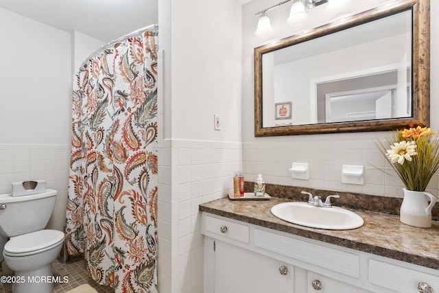 bathroom featuring tile walls, vanity, tile patterned flooring, and toilet