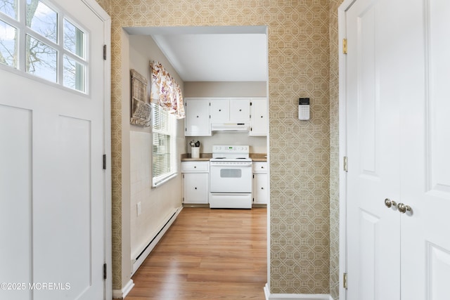 kitchen with baseboard heating, white cabinetry, white electric range oven, and light hardwood / wood-style floors