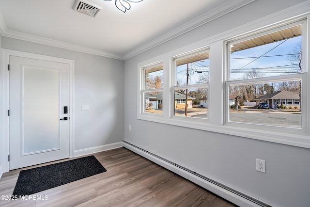 doorway to outside featuring hardwood / wood-style flooring, crown molding, and baseboard heating