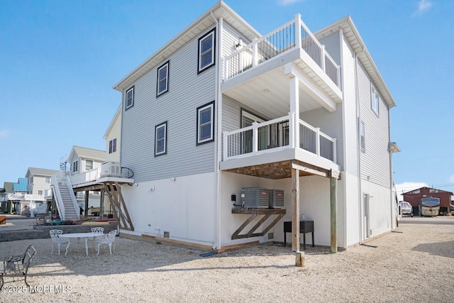 rear view of house featuring cooling unit