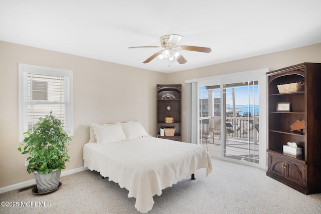 carpeted bedroom featuring access to exterior and ceiling fan