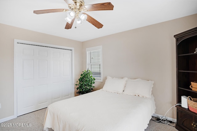 carpeted bedroom featuring ceiling fan and a closet