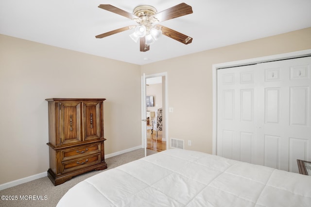 carpeted bedroom with a closet and ceiling fan