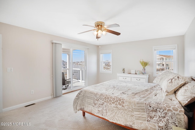 carpeted bedroom with ceiling fan and access to exterior