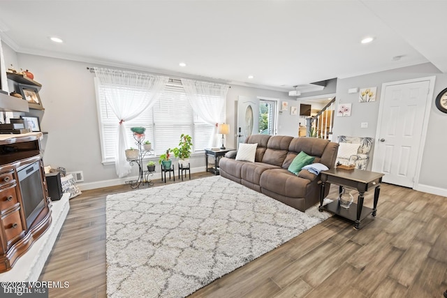 living room with ornamental molding and hardwood / wood-style floors