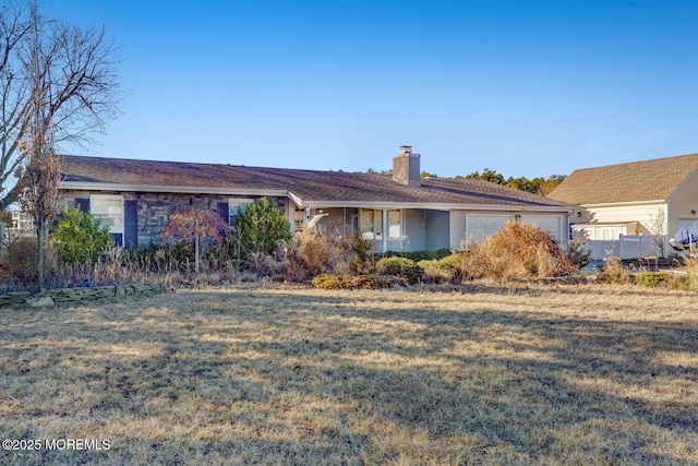 ranch-style home with a garage and a front yard