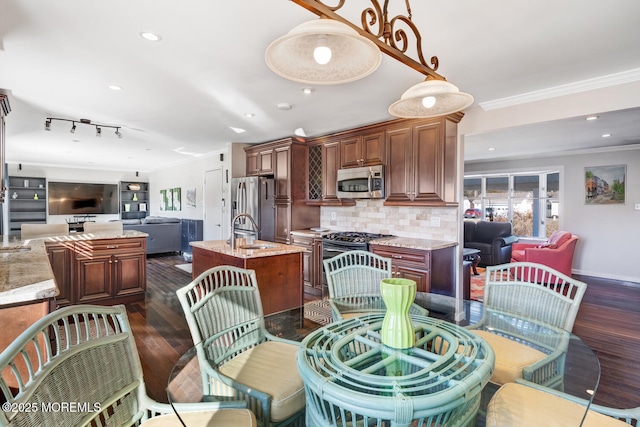 dining space with sink, ornamental molding, and dark hardwood / wood-style floors