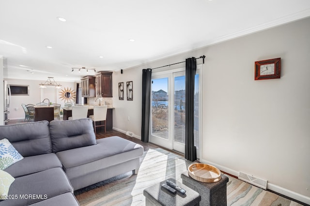 living room with ornamental molding and dark hardwood / wood-style floors