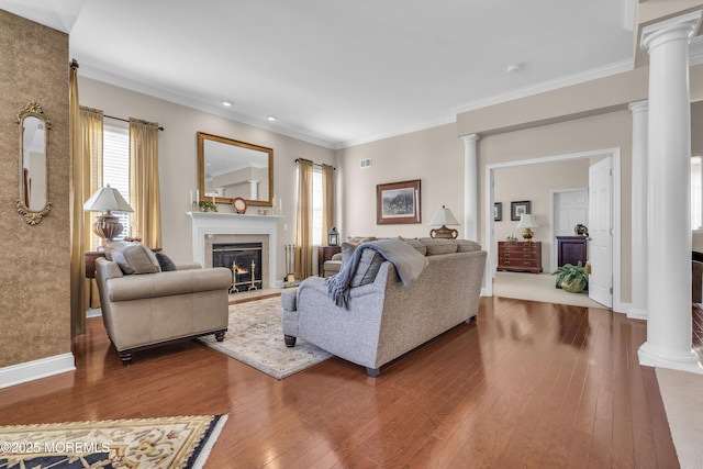 living room featuring crown molding, hardwood / wood-style flooring, and decorative columns