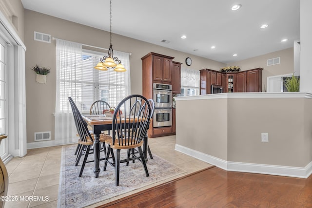 dining area featuring light wood-type flooring