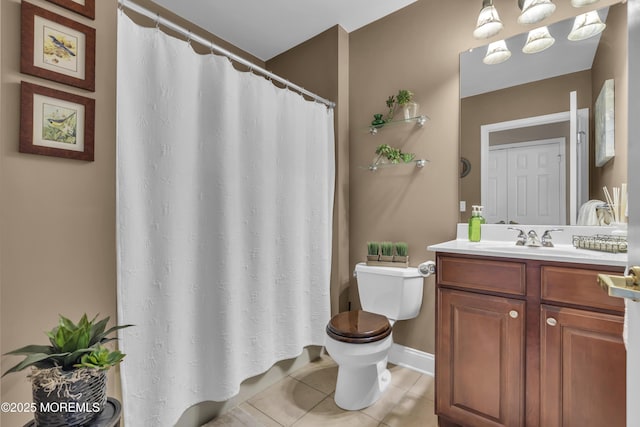 bathroom with tile patterned flooring, vanity, and toilet