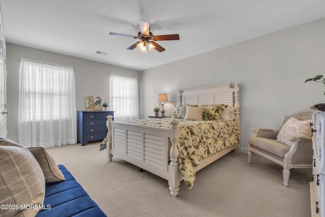 bedroom featuring light colored carpet and ceiling fan