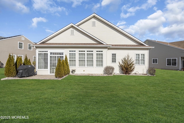 rear view of house with a lawn and a patio