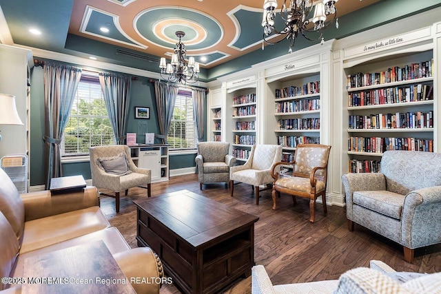 sitting room featuring an inviting chandelier, dark hardwood / wood-style flooring, and crown molding