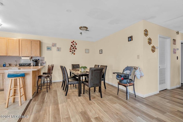 dining space with light hardwood / wood-style flooring