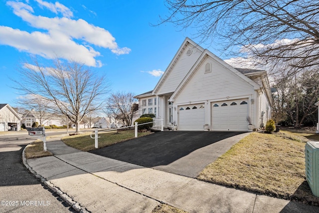 view of home's exterior featuring a yard and a garage