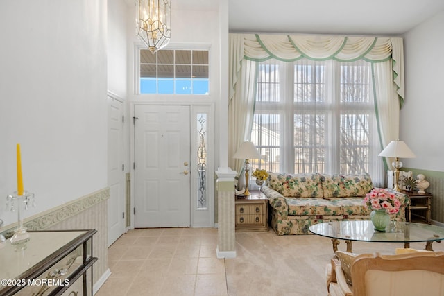 tiled foyer with a notable chandelier