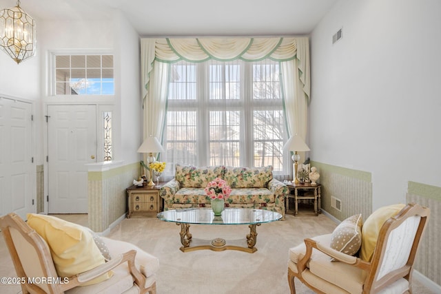 living room featuring light carpet and a chandelier