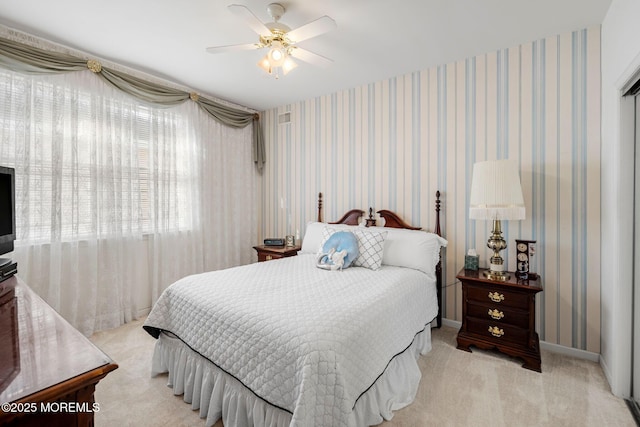 bedroom with light carpet and ceiling fan