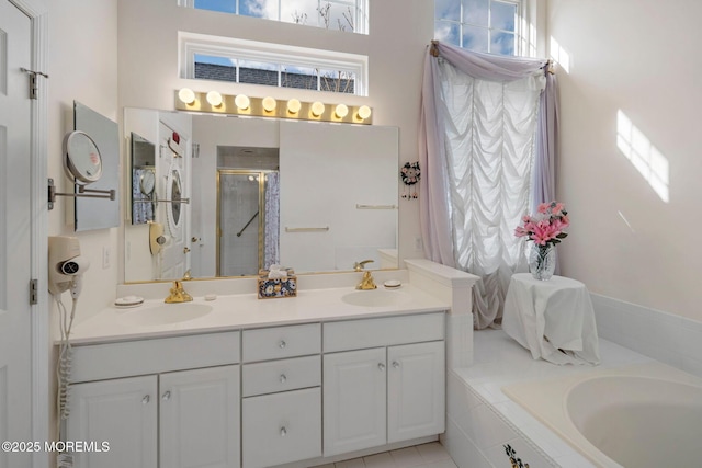 bathroom with shower with separate bathtub and vanity