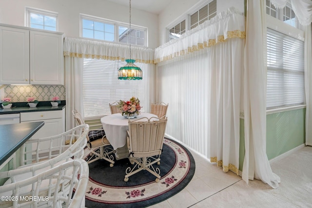 tiled dining room featuring a high ceiling