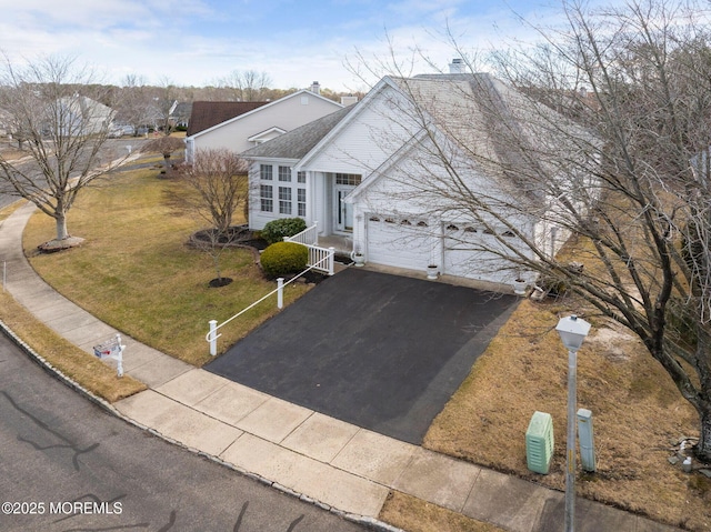 view of front of home featuring a garage and a front yard